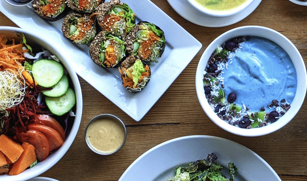 Colourful vegan salad, smoothie bowl, and wrap.